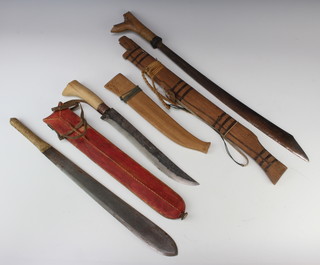 A Maw maw terrorist double bladed knife 39cm complete with red scabbard, an Eastern sword with 15cm blade  and wooden scabbard (blade rusted), an Eastern dagger with 28cm blade and wooden scabbard
