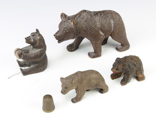 A Swiss carved wooden figure of a bear together with 3 other carved figures of bears and a thimble 
