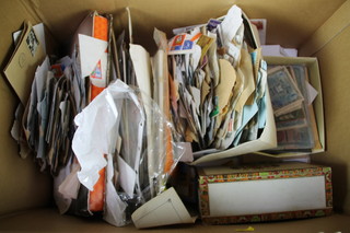 A box containing a large collection of loose world stamps 