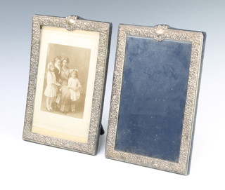 A pair of repousse silver rectangular photograph frames with vacant cartouches 22cm x 18.5cm 