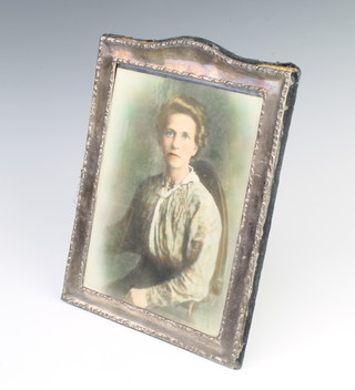 A silver photograph frame with repousse decoration London 1988, 27cm x 20cm 