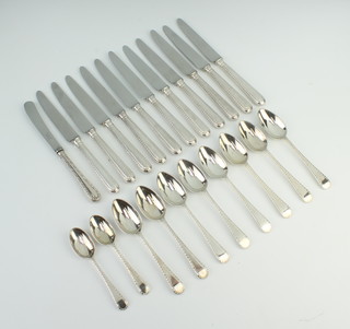 Eight silver tea spoons with bright cut decoration London 1981, 2 do. coffee spoons, 270 grams and 12 silver handled butter knives 