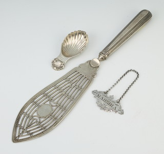 A Georgian style silver caddy spoon with scalloped bowl and shell handle Birmingham 1972, a fish slice and Madeira label 
