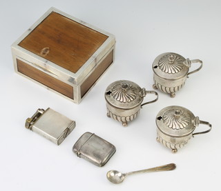 A matched set of 3 silver repousse mustard pots on ball feet London 1890 and Sheffield 1905 140 grams together with a mounted cigarette case, plated cigarette lighter, vesta and spoon 
