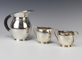 An Art Deco silver baluster jug with ebony handle, a do. cream jug and sugar bowl, gross 478 grams