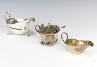 A silver sauce boat with S scroll handle on hoof feet London 1935, a smaller do. and a silver mustard