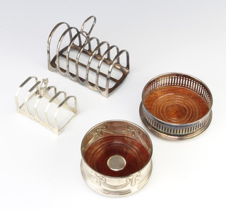 An Edwardian silver 7 bar toast rack, 1 other, a silver coaster and a plated coaster