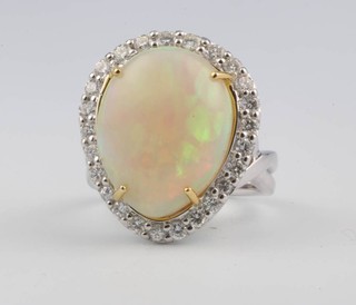 An 18ct white gold pear cut opal and diamond ring, the centre stone 10.6ct surrounded by brilliant cut diamonds 1ct, size N 1/2