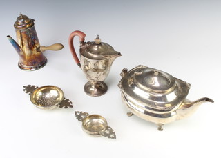 A silver hot water jug of Adam form London 1935, a silver teapot, 2 strainers and a jug