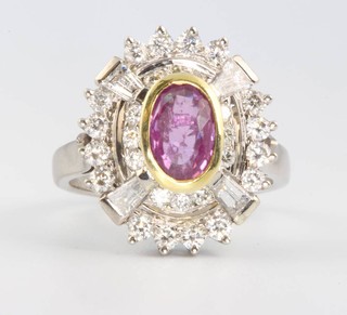 A 14ct white gold oval pink sapphire and diamond cluster ring size P