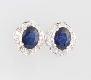A suite of 14ct white gold sapphire and diamond jewellery comprising a ring size P, a pendant and a pair of ear studs 