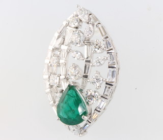 A 14ct white gold emerald and diamond oval pendant, the pear cut emerald approx. 5.1ct surrounded by brilliant and baguette cut diamonds approx 6.15ct 43mm x 26mm 
