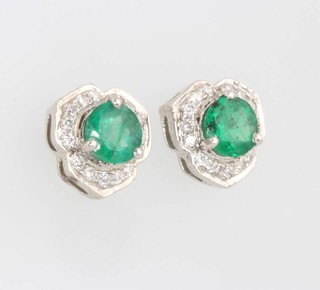 A suite of 14ct white gold emerald and diamond jewellery comprising a ring size L 1/2, a pendant and pair of ear studs 