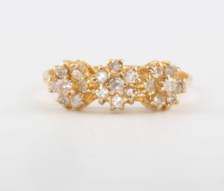 An 18ct yellow gold diamond triple cluster ring size N