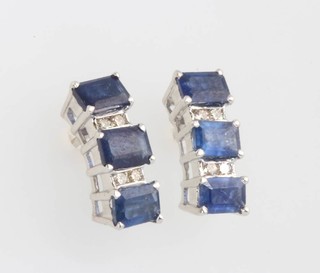 A pair of 18ct white gold baguette cut sapphire and diamond ear studs 