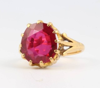 A 22ct yellow gold ring with red gem set oval stone, size P 1/2