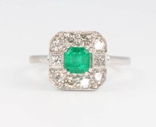 An 18ct white gold art deco style emerald and diamond ring Size M 1/2