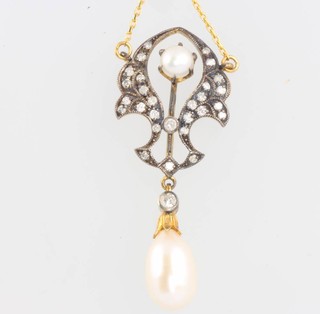 An Edwardian style diamond and pearl set pendant on a gilt chain 