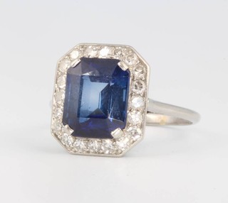 A platinum, diamond and synthetic sapphire octagonal cocktail ring, the main stone approx. 3ct surrounded by brilliant cut diamonds approx. 0.6ct, size S 1/2