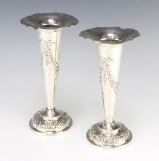 A pair of Edwardian repousse silver spill vases with floral decoration London 1909, 19cm 236 grams