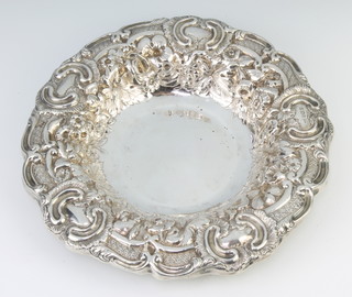 A Victorian repousse silver circular dish decorated with flowers, Sheffield 1898, maker Walker and Hall 24cm, 340 grams  