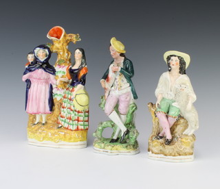 A Staffordshire spill vase with 2 ladies and a child 25cm, do. with a young man and dog 24cm and a shepherd and sheep 20cm 
