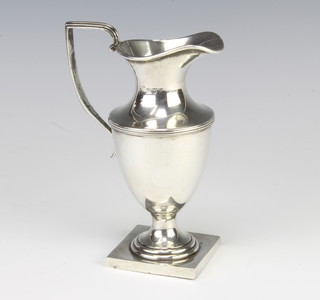 An Edwardian silver cream jug of urn form Chester 1908 129 grams