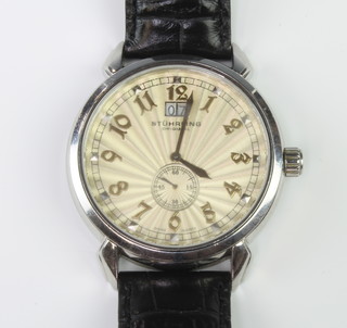 A gentleman's steel cased Stuhrling automatic wristwatch with calendar and seconds dial on a leather strap 