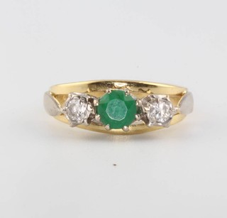 A yellow gold emerald and diamond ring size H 