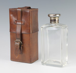A glass spirit bottle with silver lid London 1912, 16cm contained in a fitted leather case