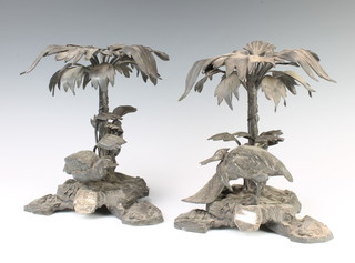 A pair of Victorian Elkington & Co silver plated table centre pieces with exotic beasts beneath trees, raised on rocky bases 24cm 