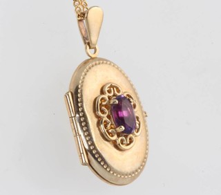 A 9ct yellow gold amethyst set locket on an 18ct yellow gold chain 