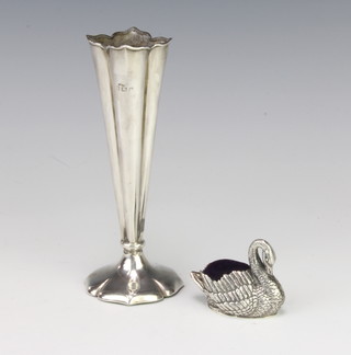 A sterling silver pin cushion in the form of a swan and a silver tapered posy vase 