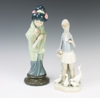 A Lladro figure of a Japanese lady holding a fan 28cm, a do. of a girl with a family of geese 23cm 