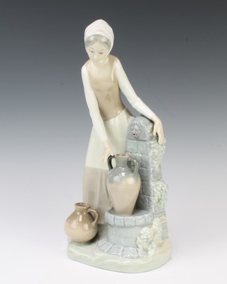 A Nao figure of a lady by a water fountain 28cm 