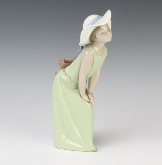 A Lladro figure of a girl leaning on her knee 23cm 