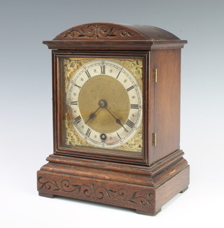 Winterhalder and Hofmeier, a timepiece with gilt dial and silvered chapter ring contained in a carved arched shaped case  
