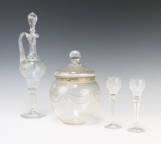 A 19th Century Continental baluster spirit decanter and stopper with floral decoration 32cm, a pair of ensuite liqueurs 14cm and a silver mounted cut glass jar 18cm 