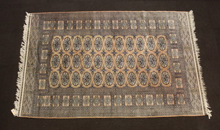 A pink ground Bokhara carpet with 33 octagons to the centre  241cm x 154cm 