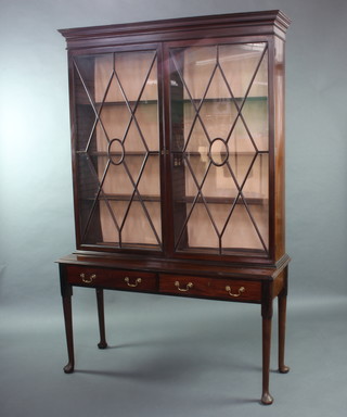 A Georgian mahogany bookcase on stand, the upper section with moulded cornice, fitted adjustable shelves enclosed by astragal glazed panelled doors, the base fitted 2 long drawers with brass swan neck drop handles, raised on club supports (made up, the base was formerly the base of a gateleg table) 202cm h x 130cm x 45cm 

