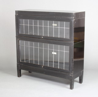 An ebonised Globe Wernicke 2 section bookcase enclosed by lead glazed panelled doors, raised on square tapered supports 92cm h x 86cm w x 29cm d 