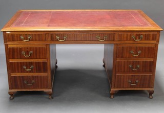 A mahogany kneehole desk with red inset leather writing surface above 1 long and 6 short drawers raised on cabriole supports 76cm x 153cm x 90cm 