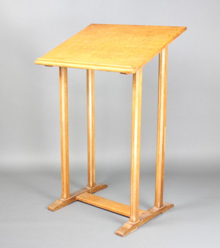 A light oak lectern raised on 4 chamfered supports with H framed stretcher 120cm h x 76cm w x 60cm d 
