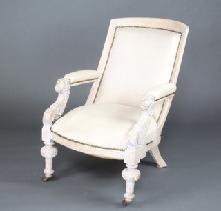 A Victorian limed oak open arm chair with lion mask arms, upholstered in light coloured material, raised on turned supports 