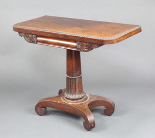 A William IV D shaped rosewood card table raised on a turned column and triform base 74cm h x 91cm w x 45cm d  