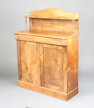 A 19th Century bleached mahogany chiffonier with raised back, fitted a cupboard enclosed by panelled doors, on a platform baes 122cm h x 93cm w x 36cm d 
