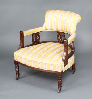 An Edwardian mahogany tub back chair upholstered in yellow Regency stripe material, raised on turned supports 