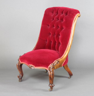 A Victorian rosewood show frame chair upholstered in red buttoned material raised on carved cabriole supports 