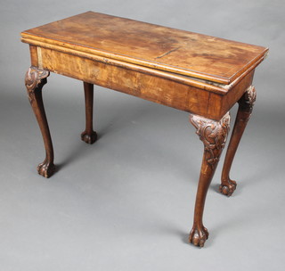 A 19th Century rectangular mahogany card table raised on carved cabriole ball and claw supports 72cm x 91cm x 45cm 
