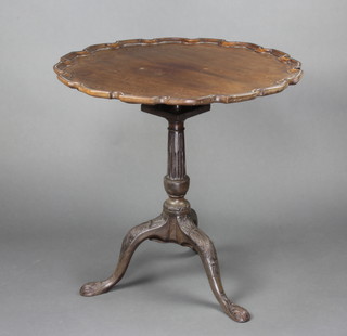 A 19th Century circular Chippendale style mahogany bird cage table with pie crust top, raised on turned and fluted column with carved tripod base 70cm x 71cm
